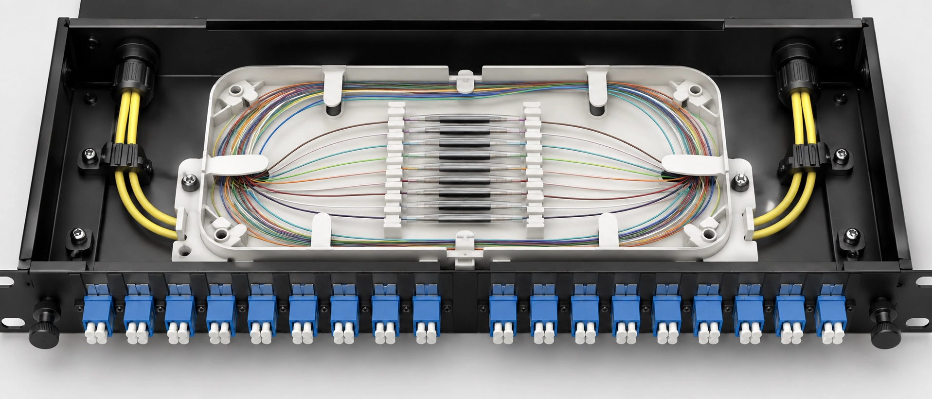 Fiber pigtail fusion splicing inside a patch panel splice tray showing organized fiber loops and heat shrink sleeve holders Fiber pigtail fusion splicing inside a patch panel splice tray showing organized fiber loops and heat shrink sleeve holders